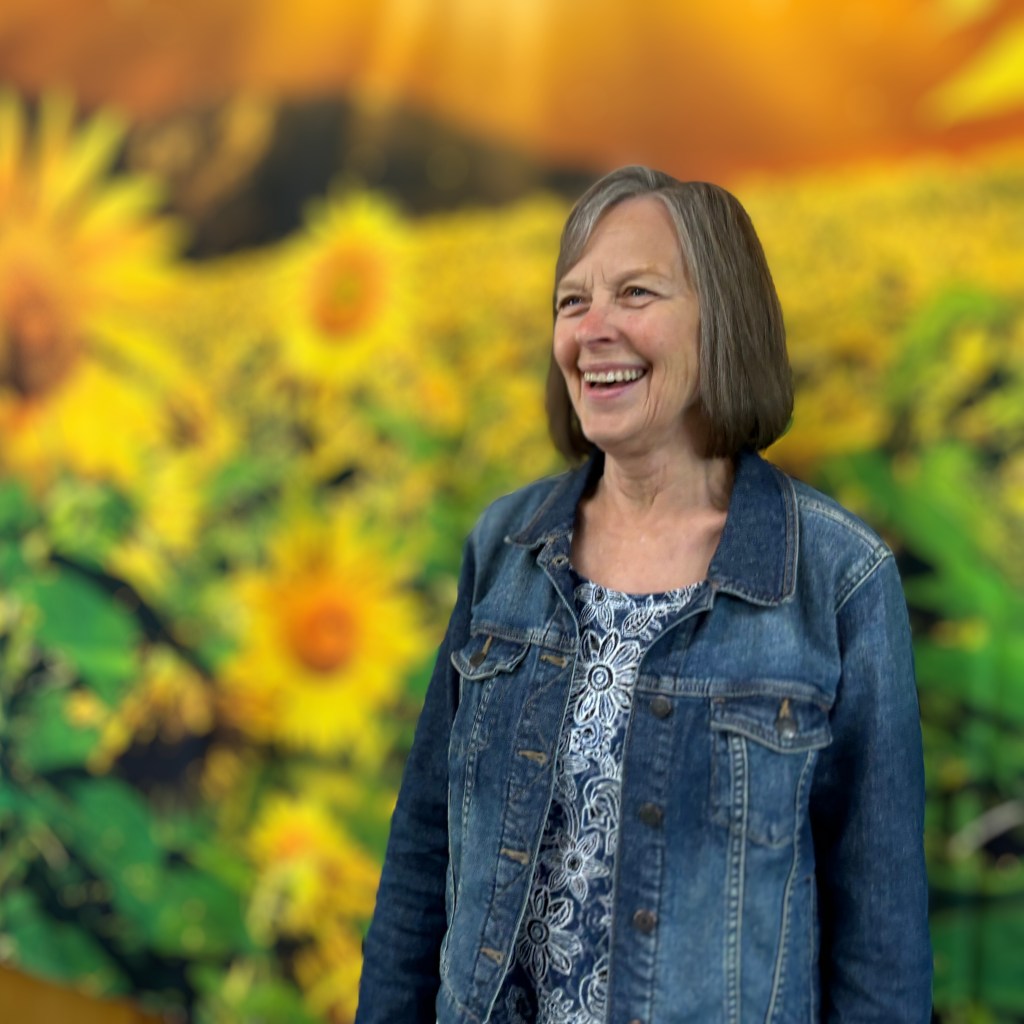 Photo of Marlys with sunflowers